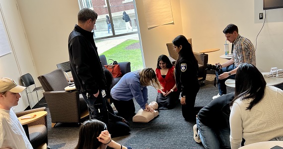 Students being trained in CPR on mannequins with Drexel EMS staff